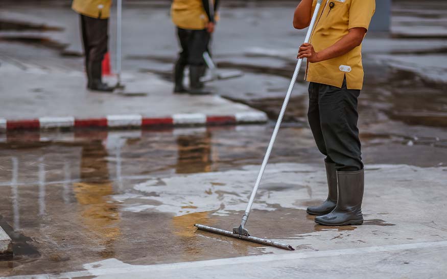 Workers cleaning and maintaining a parking lot